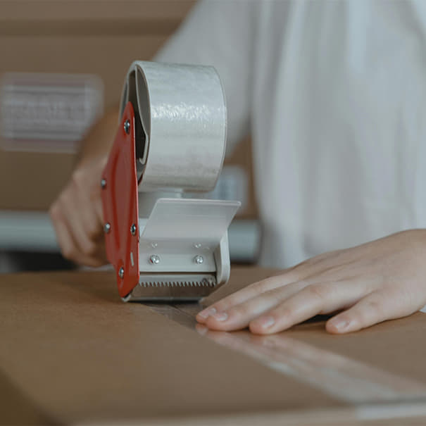 Cardboard box being taped